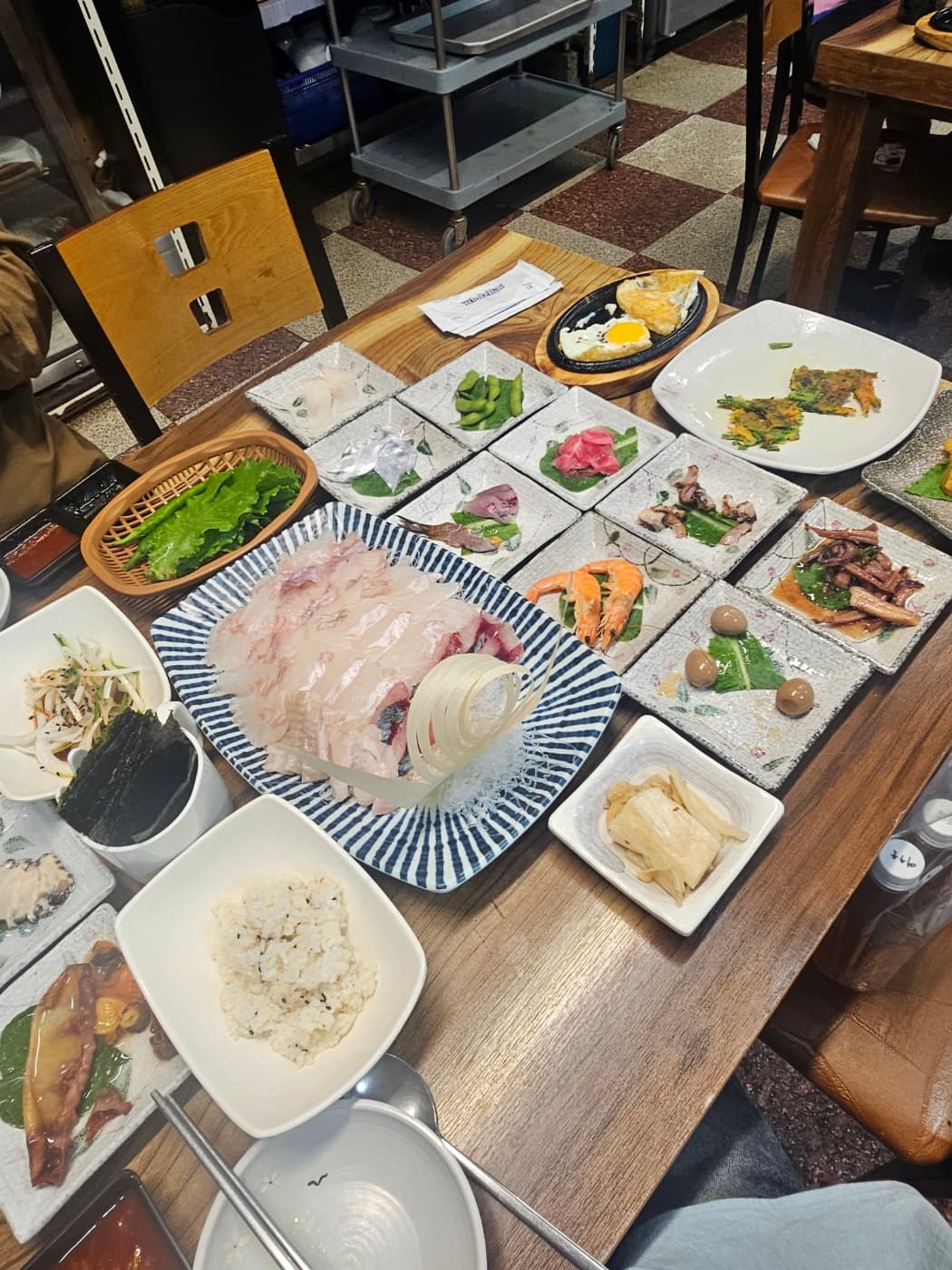 Korean sashimi meal served with many small side dishes